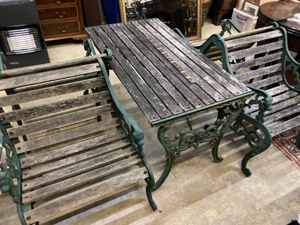 Four cast metal slatted wood garden armchairs and matching rectangular table, table 126 x 67cm, height 65cm